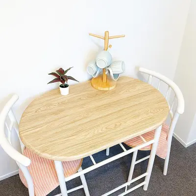 a wooden table with two chairs and a plant on it at \u6c60\u888b \u5de3\u9d28 YMhotel \u6700\u592718\u540d\u53ef-ikebukuro sugamo- in Tokyo