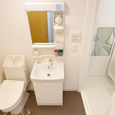 a bathroom with a toilet and a sink and a mirror at \u6c60\u888b \u5de3\u9d28 YMhotel \u6700\u592718\u540d\u53ef-ikebukuro sugamo- in Tokyo