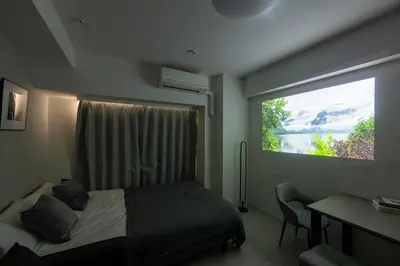a bedroom with a bed and a window with a desk at LIVCITY Kinshicho 301 in Tokyo