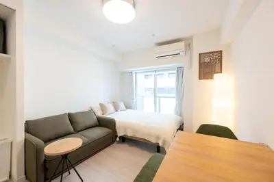 a living room with a couch and a bed at LIVCITY Kinshicho 401 in Tokyo