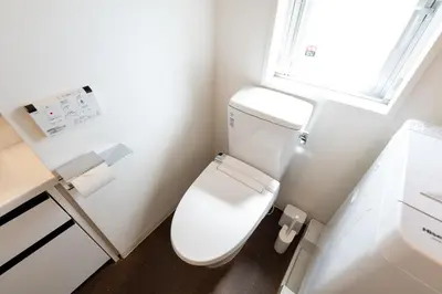 a white toilet in a bathroom with a window at LIVCITY Kinshicho 501 in Tokyo