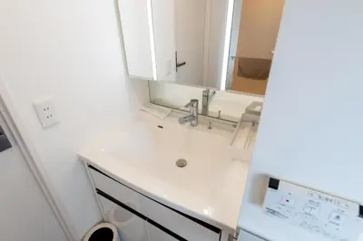 a white bathroom with a sink and a mirror at LIVCITY Kinshicho 501 in Tokyo