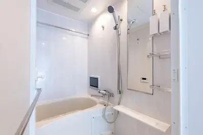 a white bathroom with a tub and a shower at LIVCITY Kinshicho 502 in Tokyo