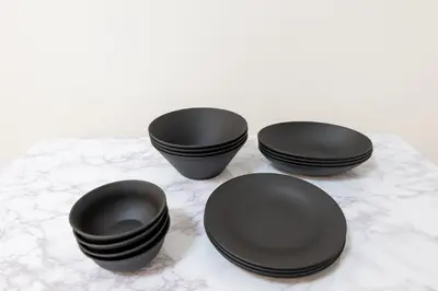 three black plates sitting on a table at LIVCITY Kinshicho 502 in Tokyo