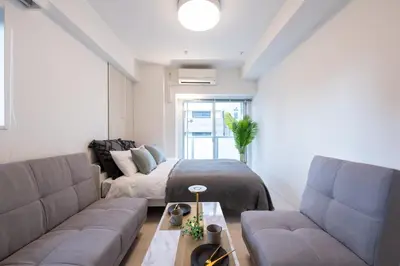 a living room with a couch and a bed at LIVCITY Kinshicho 502 in Tokyo
