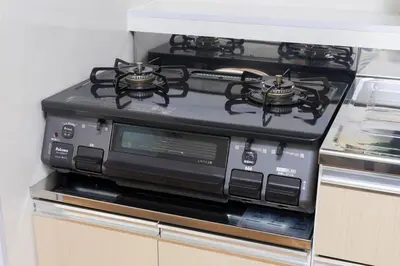 a black stove top oven in a kitchen at 3 bedrooms, 5-minute walk to Shinjuku City Center, Isetan department store , max 7 people in Tokyo