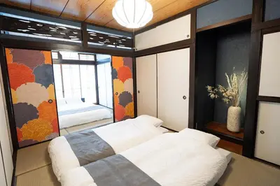 a bedroom with a large bed and a window at Max 15 people OK,2-minute walk from the station, Japanese-style modern 6LDK house in Tokyo
