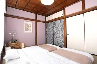 a bedroom with a large white bed and a window at Max 15 people OK,2-minute walk from the station, Japanese-style modern 6LDK house in Tokyo