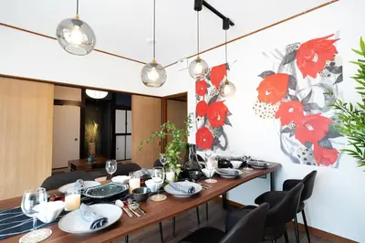 a dining room with a table with plates and candles at Max 15 people OK,2-minute walk from the station, Japanese-style modern 6LDK house in Tokyo