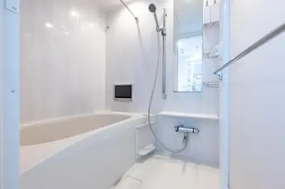 a white bathroom with a tub and a shower at LIVCITY Kinshicho 601 in Tokyo