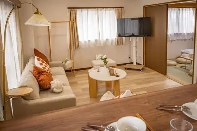 a living room with a couch and a table at 2BR Apartment Only 2 Stops to Shinjuku Includes Baby Essentials & Luggage Hold in Tokyo