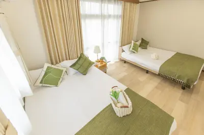 a bedroom with two beds and a window at 2BR Apartment Only 2 Stops to Shinjuku Includes Baby Essentials & Luggage Hold in Tokyo