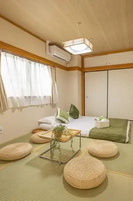 a room with two beds and a glass table at 2BR Apartment Only 2 Stops to Shinjuku Includes Baby Essentials & Luggage Hold in Tokyo