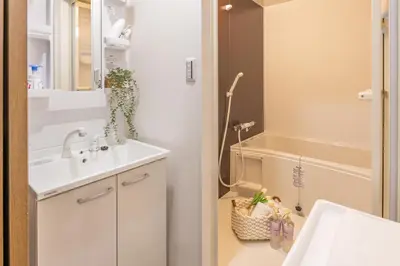 a bathroom with a sink and a tub at 2BR Apartment Only 2 Stops to Shinjuku Includes Baby Essentials & Luggage Hold in Tokyo