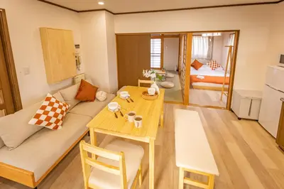 a living room with a couch and a table at Near Shinjuku 2-Story Family & Group-Friendly Home 5 Bedrooms, Fits 14 Guests in Tokyo