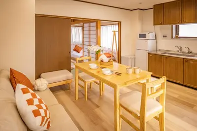 a kitchen and living room with a table and a couch at Near Shinjuku 2-Story Family & Group-Friendly Home 5 Bedrooms, Fits 14 Guests in Tokyo
