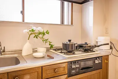 a kitchen with two pots and pans on a stove at Near Shinjuku 2-Story Family & Group-Friendly Home 5 Bedrooms, Fits 14 Guests in Tokyo