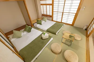 a room with two beds and a table and chairs at Near Shinjuku 2-Story Family & Group-Friendly Home 5 Bedrooms, Fits 14 Guests in Tokyo