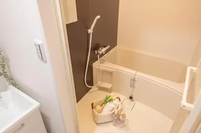 a small bathroom with a tub and a basket of shoes at Near Shinjuku 2-Story Family & Group-Friendly Home 5 Bedrooms, Fits 14 Guests in Tokyo