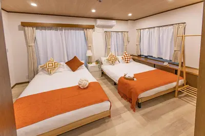 a bedroom with two beds and two windows at Near Shinjuku 2-Story Family & Group-Friendly Home 5 Bedrooms, Fits 14 Guests in Tokyo