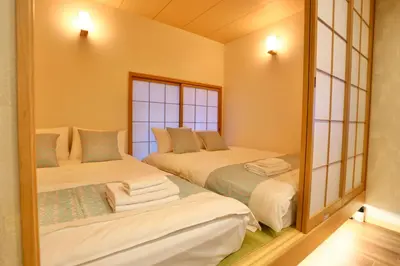a bedroom with two beds and a mirror at New 2BR Ueno Home 2 Minutes Walk to Metro Station in Tokyo