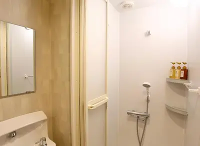 a bathroom with a white toilet and a mirror at New 2BR Ueno Home 2 Minutes Walk to Metro Station in Tokyo