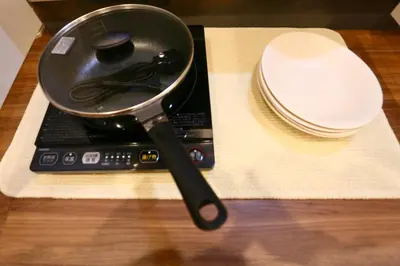a frying pan sitting on top of a laptop at New 2BR Ueno Home 2 Minutes Walk to Metro Station in Tokyo