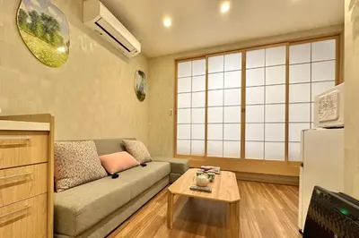 a living room with a couch and a table at New 2BR Ueno Home 2 Minutes Walk to Metro Station in Tokyo