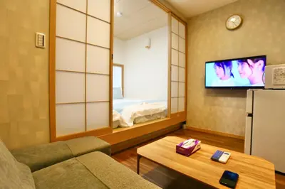 a living room with a couch and a tv at New 2BR Ueno Home 2 Minutes Walk to Metro Station in Tokyo
