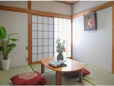a room with a table with a vase on it at Two bathrooms, two toilets 6 mins walking distance from Keisei Takasago Station in Tokyo