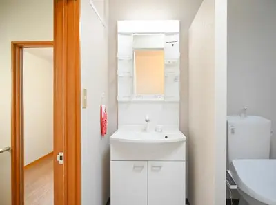 a white bathroom with a sink and a mirror at Two bathrooms, two toilets 6 mins walking distance from Keisei Takasago Station in Tokyo