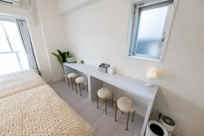 a bedroom with a bed and a desk with stools at LIVCITY Kinshicho 801 in Tokyo