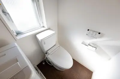 a white toilet in a bathroom with a window at LIVCITY Kinshicho 802 in Tokyo
