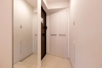 a hallway with white walls and a white door at LIVCITY Kinshicho 802 in Tokyo