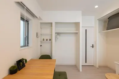 a room with a wooden table and a door at LIVCITY Kinshicho 901 in Tokyo