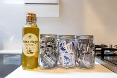 a bottle of olive oil sitting next to three jars at LIVCITY Kinshicho 901 in Tokyo