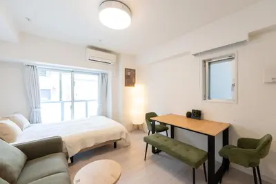 a bedroom with a bed and a desk and a table at LIVCITY Kinshicho 901 in Tokyo