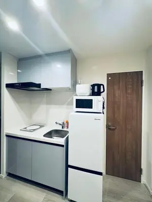 a kitchen with a white refrigerator and a sink at Higashiasakusa house 1F-TT0365 in Tokyo