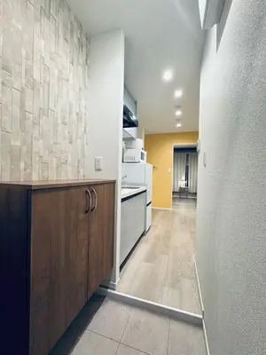 a kitchen with white appliances and wooden cabinets at Higashiasakusa house 1F-TT0365 in Tokyo