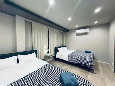 a bedroom with two beds and a window at Higashiasakusa house 1F-TT0365 in Tokyo