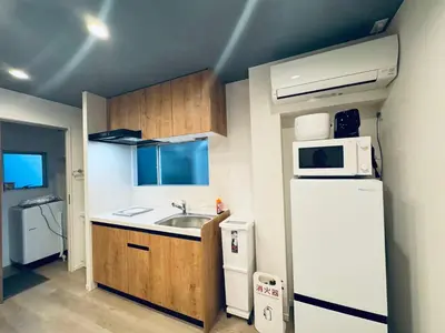 a small kitchen with a sink and a refrigerator at Higashiasakusa House 2-3F-TT0366 in Tokyo