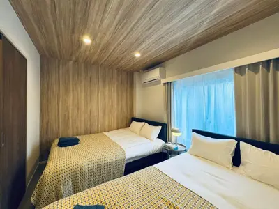 a small room with two beds and a window at Higashiasakusa House 2-3F-TT0366 in Tokyo