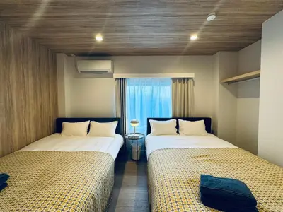 two beds in a room with a window at Higashiasakusa House 2-3F-TT0366 in Tokyo