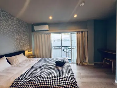 a bedroom with a bed with a black bag on it at Higashiasakusa House 2-3F-TT0366 in Tokyo