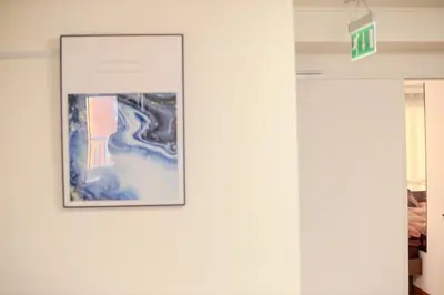 a picture hanging on a wall in a room at \u30b5\u30f3\u30e9\u30a4\u30d5\u677e\u304c\u8c37 in Tokyo