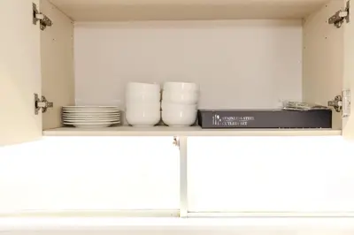 a shelf with plates and dishes on it in a kitchen at \u30b5\u30f3\u30e9\u30a4\u30d5\u677e\u304c\u8c37 in Tokyo