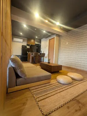 a living room with a couch and a table at Quiet residential room 408 walking distance of Shinjuku in Tokyo