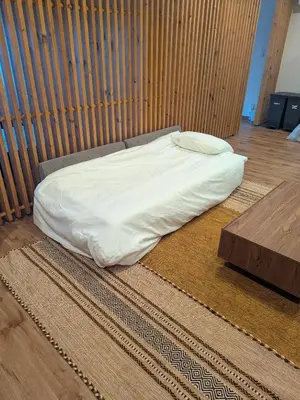 a bed with a white sheet on the floor at Quiet residential room 408 walking distance of Shinjuku in Tokyo