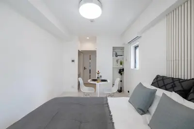a white room with a bed and a table at LIVCITY Kinshicho 1102 Skytree view in Tokyo