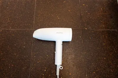 a white nintendo wii controller sitting on the floor at LIVCITY Kinshicho 1102 Skytree view in Tokyo